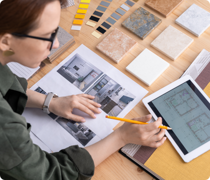 A designer referencing inspiration images while reviewing their client&rsquo;s floor plan.