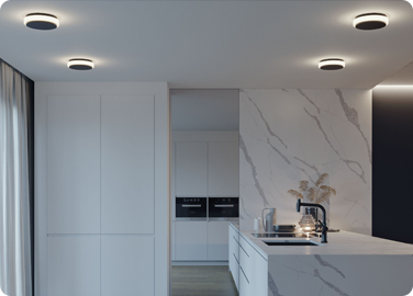 Sleek lighting and furnishings with matte black finishes help to create a chic modern kitchen.