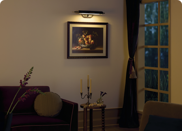 A picture light adds a point of interest in an elegant living room.