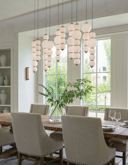 Statement chandelier centerpiece above dining room table.