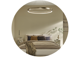 An LED ring chandelier looks chic and provides ample light as part of a layered plan.