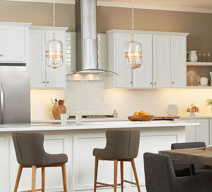 A modern kitchen with dimmable island pendants and undercabinet lighting for highly-functional task surfaces.