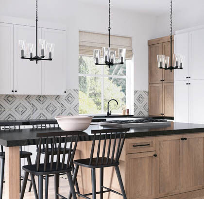 Kitchen island with three small pendants spaced properly above the countertop.