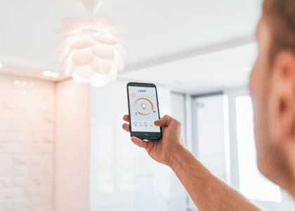 Designer using smart lighting controls to demonstrate future-ready fixtures