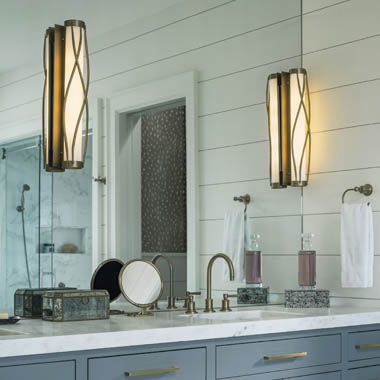 A master bathroom vanity lit by artisan, handmade sconces.