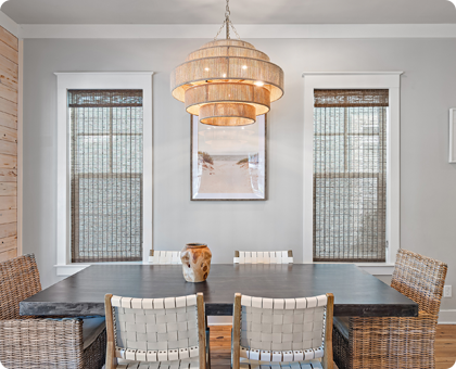 A dining room is illuminated by a beautiful, natural chandelier.