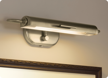 A picture light adding visual interest to a room by accenting wall art