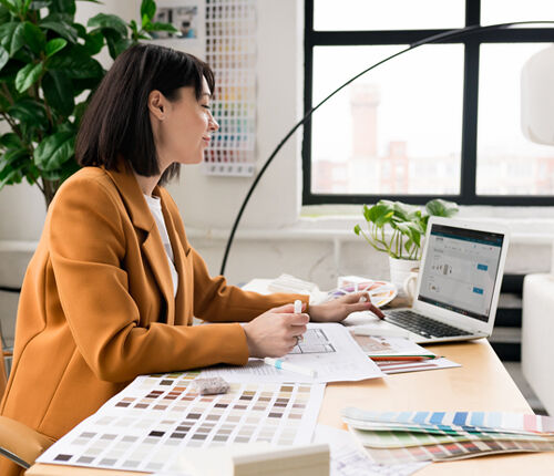 Designer reviewing lighting specifications to avoid common lighting mistakes in residential projects.