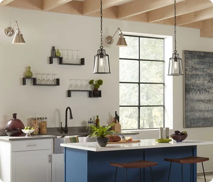 A small kitchen workspace includes both black pendants and nickel wall sconces for an attractive variety of finishes.