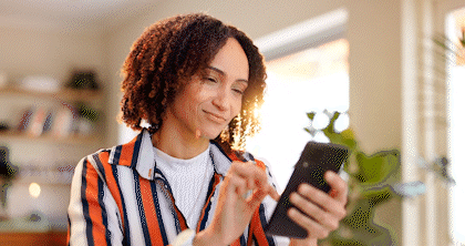 A homeowner happily scrolls through lighting options provided by Beacon.