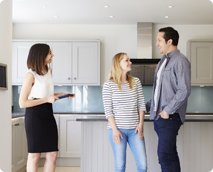 A young couple considers the lighting in a home while making their decision.