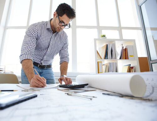  Lighting professional reviewing project plan comparing fixture quality vs. cost