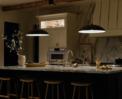 A modern kitchen showing layers of light in use during the evening.