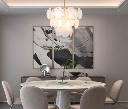 Layered glass diffuses light above a dining room table for a soft, opulent glow.