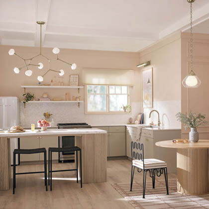 Layered kitchen lighting minimizes stress and provides ample illumination in a high-traffic, task-oriented space.