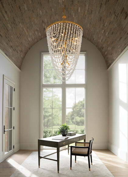 Oversized chandelier lighting fixture creating dramatic impact in a living room.