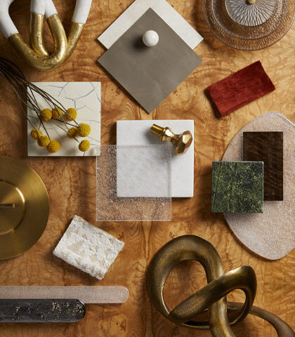 Sustainable lighting materials including brass, metal, and glass used in fixture design.