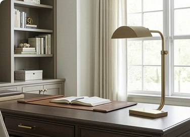 A desk lamp immediately establishes a work zone, even in a multi-use space.