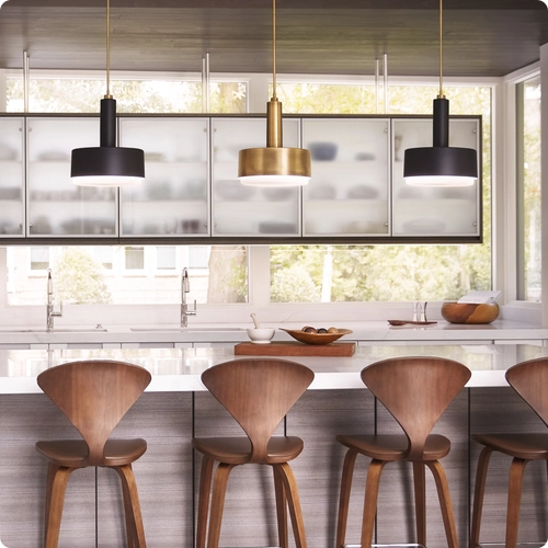  A playful mix of black and brass above a kitchen island adds a fun, modern vibe to the workspace.