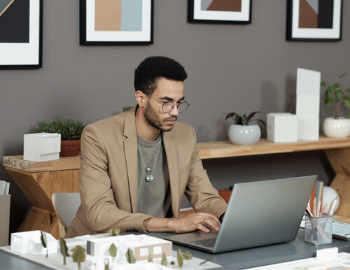 Designer reviewing lighting plans and pricing strategies for profitable lighting services in 2026.