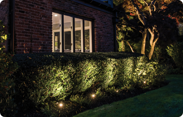 Garden uplights beautify a home's exterior after sundown