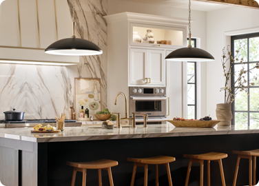 Kitchen island pendant lighting scaled properly for high ceilings and open floor plan.