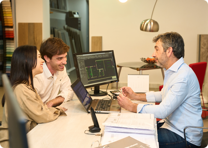 Designer reviewing lighting fixture selections with clients during project planning.