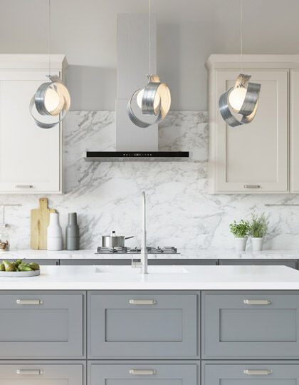 Sculptural pendant lighting used as statement lighting over kitchen island.
