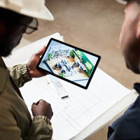 Builder reviewing lighting specifications on tablet with architect