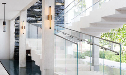 A stairway in a public space lit to provide a clear, inviting atmosphere to visitors.