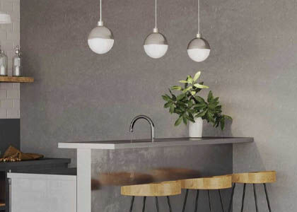 Stylish pendant lights with ENERGY STAR certification over a kitchen island