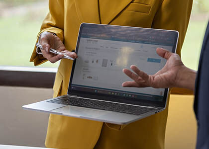 Designer presenting lighting options on a digital project board to homeowner