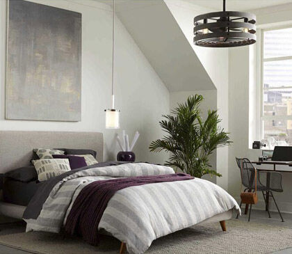 A bedroom with layered ceiling lights, allowing for a gradual shift into warm nighttime lighting.