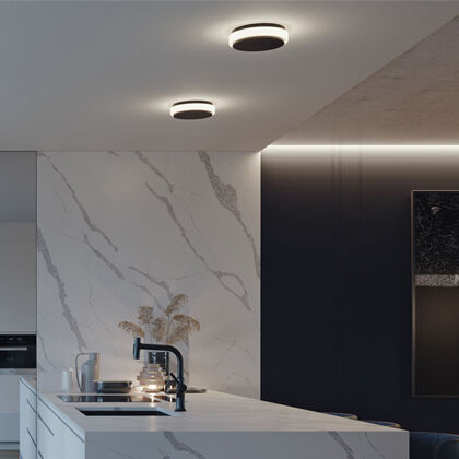 Understated flush mounts providing background lighting in a modern kitchen.