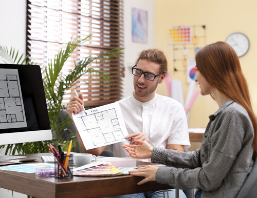 Interior designer explaining lighting plan to homeowner.