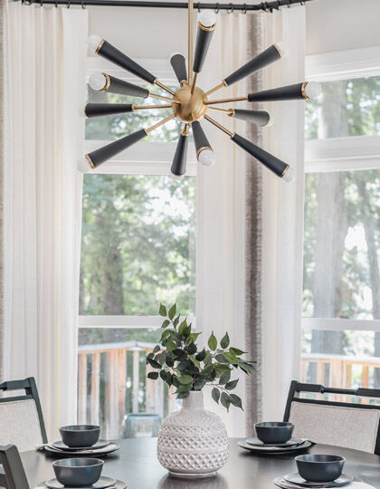 A wow moment at a dining table created by a black and brass sputnik chandelier.