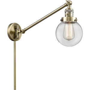 Beacon 21 inch 100 watt Antique Brass Swing Arm Wall Light in Clear Glass, Franklin Restoration